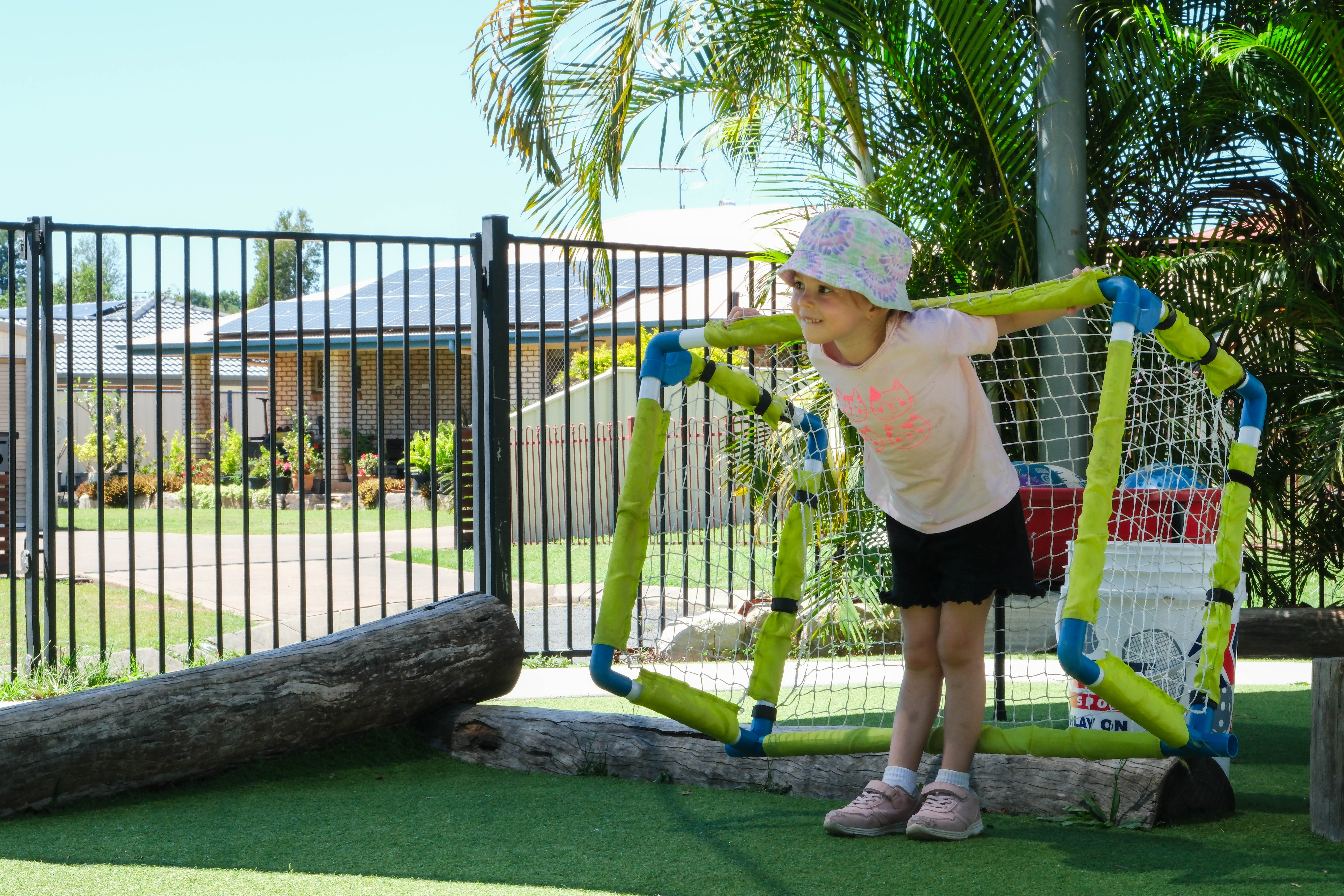 A child is playing soccer at a childcare centre